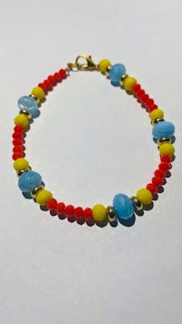 a bracelet with red, yellow and blue beads