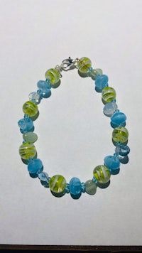 a bracelet with blue and green glass beads