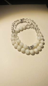 a white beaded bracelet on a table