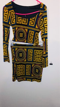 an african print dress hanging on a hanger